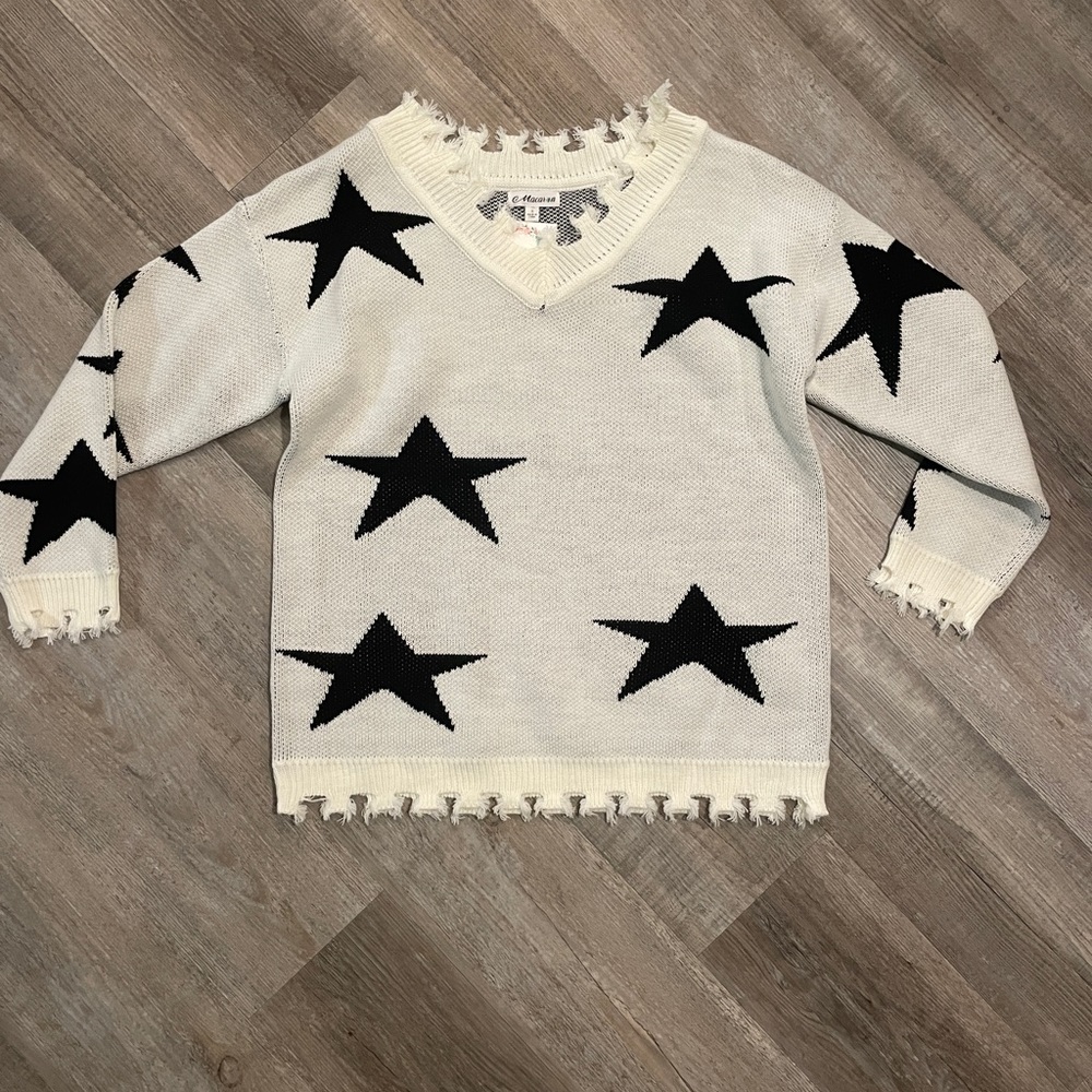 White sweater with black stars. Brand new, never been worn. With tags